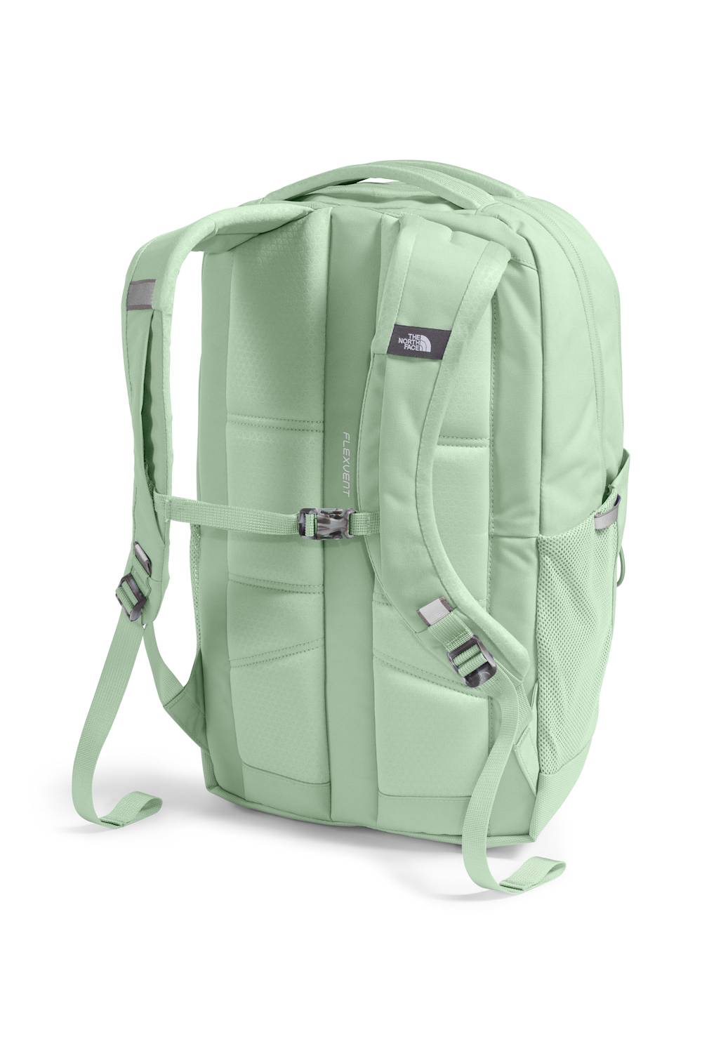 A sage green backpack shown from the back, featuring padded compartments, adjustable shoulder straps, and a small The North Face logo patch on the upper right side, set against a plain white background.
