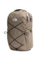 The North Face Jester backpack in a warm khaki-tan color, featuring black bungee cords crisscrossed on the front and the brand's logo on the upper left chest.