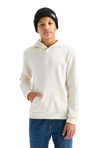 A child wearing an off-white hooded sweatshirt, blue jeans, and a black beanie with a white embroidered logo, standing against a solid white background.