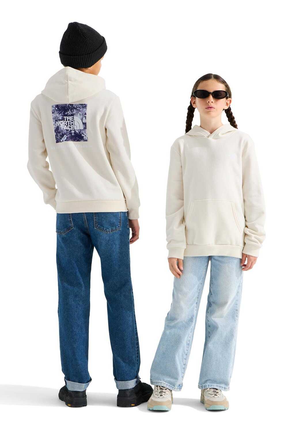 Two models wearing off-white hoodies, shown from the back and front respectively, against a plain white studio background. The model on the left wears a black beanie, blue jeans, and black shoes, while the model on the right wears sunglasses, light-wash jeans, and white sneakers.