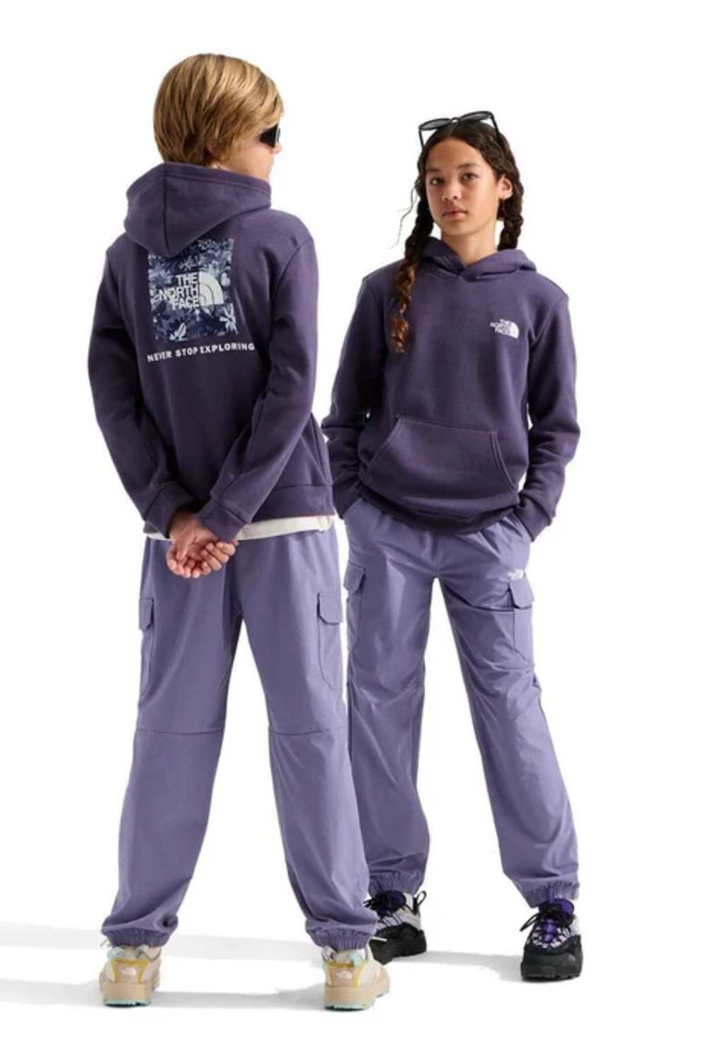 Two children modeling a matching purple hoodie and cargo pants set from The North Face, shown from both front and back views against a white studio background.