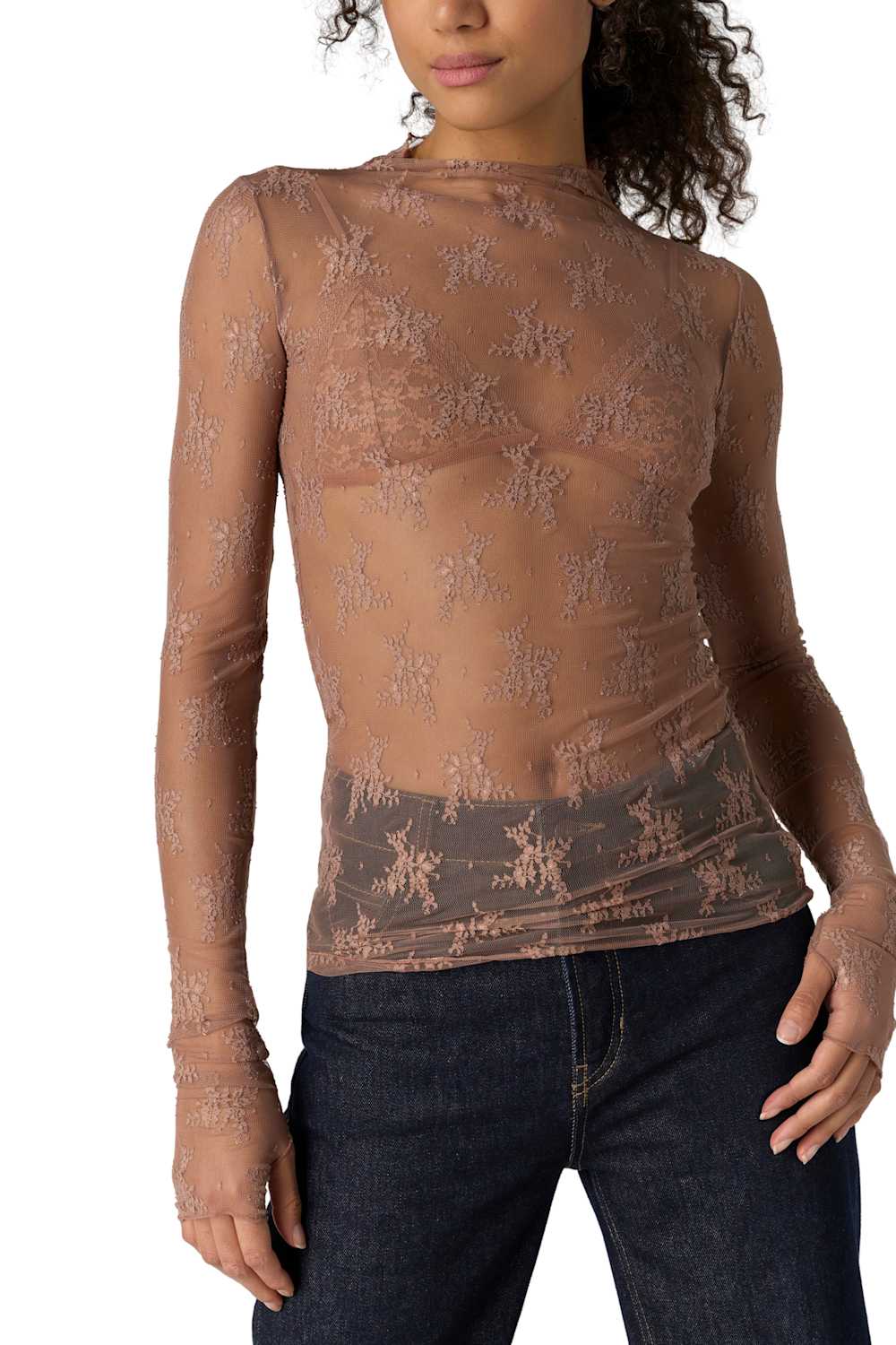 A woman wearing a sheer, long-sleeve lace top in a dusty rose-brown color, paired with dark blue jeans, shown from the back against a plain white background.