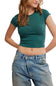 A woman wearing a fitted short-sleeve crop top in dark teal green and light-wash blue jeans, shown from the waist up against a plain white background.