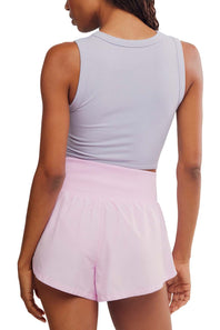 FP Movement Carpe Diem Shorts for Women in Powder Pink; Person wearing a light gray tank top and pink shorts on a white background