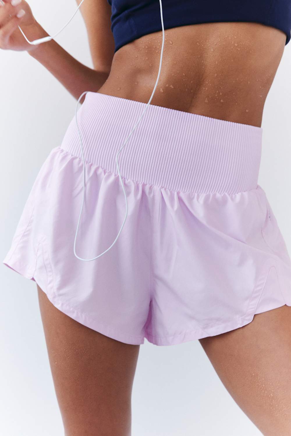 FP Movement Carpe Diem Shorts for Women in Powder Pink; Person wearing light purple athletic shorts on a white background