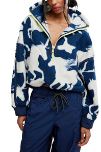 Front view showing the flat lay or product shot of the FP Movement Printed Mountain High 1/2 Zip Fleece in navy and white wild horse print, featuring a half-zip high neckline with neon yellow zipper trim, drop shoulders, side pockets, and an adjustable drawcord hem.