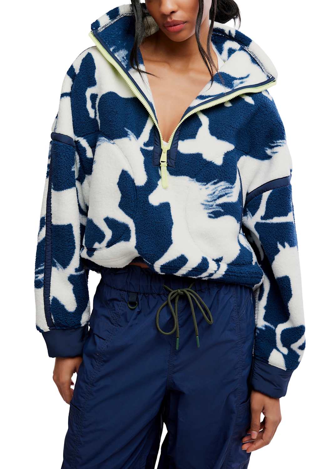 Front view showing the flat lay or product shot of the FP Movement Printed Mountain High 1/2 Zip Fleece in navy and white wild horse print, featuring a half-zip high neckline with neon yellow zipper trim, drop shoulders, side pockets, and an adjustable drawcord hem.