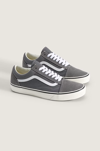A pair of gray suede Vans Old Skool sneakers with white laces and white side stripes, displayed on a light beige background.
