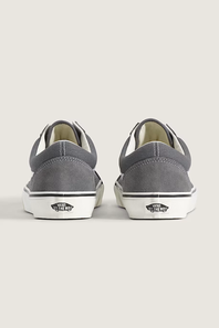 A pair of gray suede Vans Old Skool sneakers with white laces and white side stripes, displayed on a light beige background.