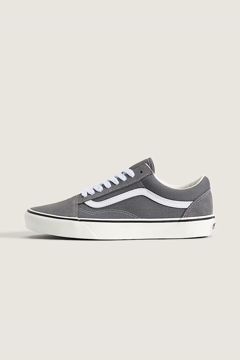 Blue and green sneaker with white sole on a light gray background