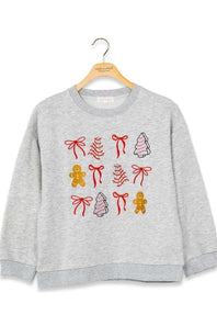 A light gray heather crewneck sweatshirt hanging on a wooden hanger, featuring a festive Christmas graphic print with red bows, gingerbread men, and decorated trees.