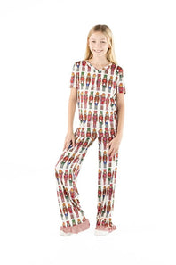 full body view of a girl wearing a matching pj set with nutcrackers all over