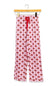 Pink wide-leg pajama pants with a red bow print pattern and a red drawstring waist, hanging on a wooden hanger against a white background.