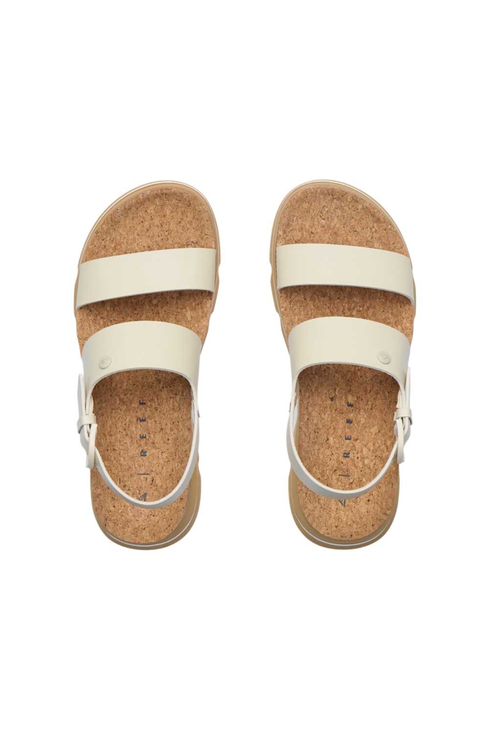 Overhead view of a pair of sandals with white straps and a cork footbed on a white background. The sandal is the Reef Vista Luxe Liah in White/Tan.