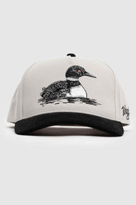 A light gray snapback cap with a black ribbed brim, featuring an embroidered loon on the front and a stylized script logo on the side.
