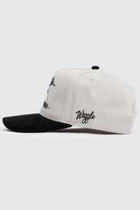 A white structured baseball cap with a black brim, featuring black embroidered graphics and the word 'Waggle' on the side, shown against a light gray background.