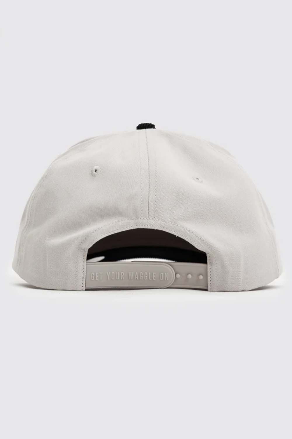 The back of a light gray snapback cap, showing the fabric panels, ventilation eyelets, and adjustable strap 