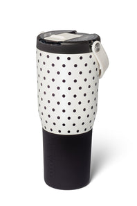 A travel tumbler with a black and white polka dot pattern on the upper half and a solid black lower half, featuring a black lid with a white flip-up straw cover and a white carrying loop.