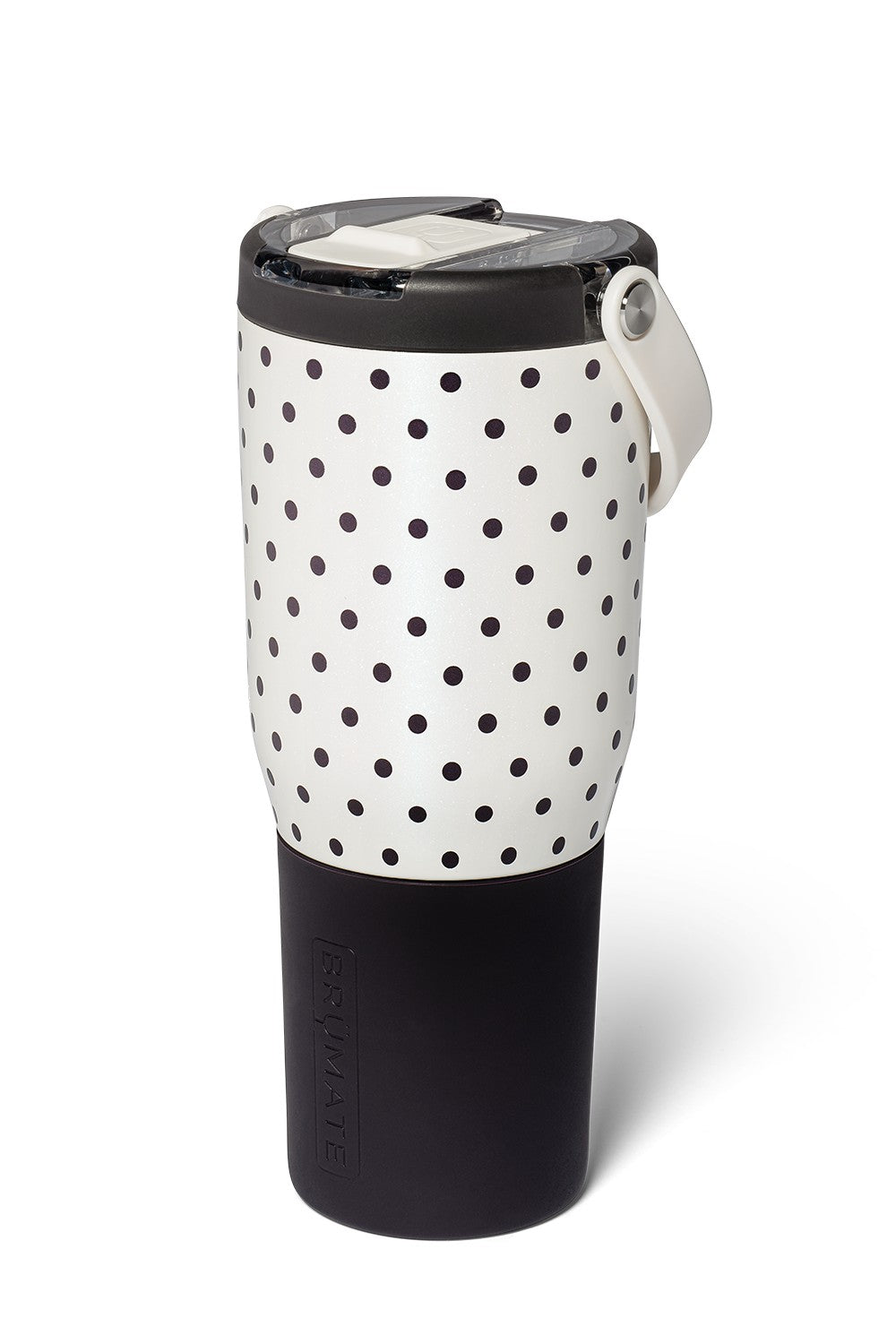 A travel tumbler with a black and white polka dot pattern on the upper half and a solid black lower half, featuring a black lid with a white flip-up straw cover and a white carrying loop.