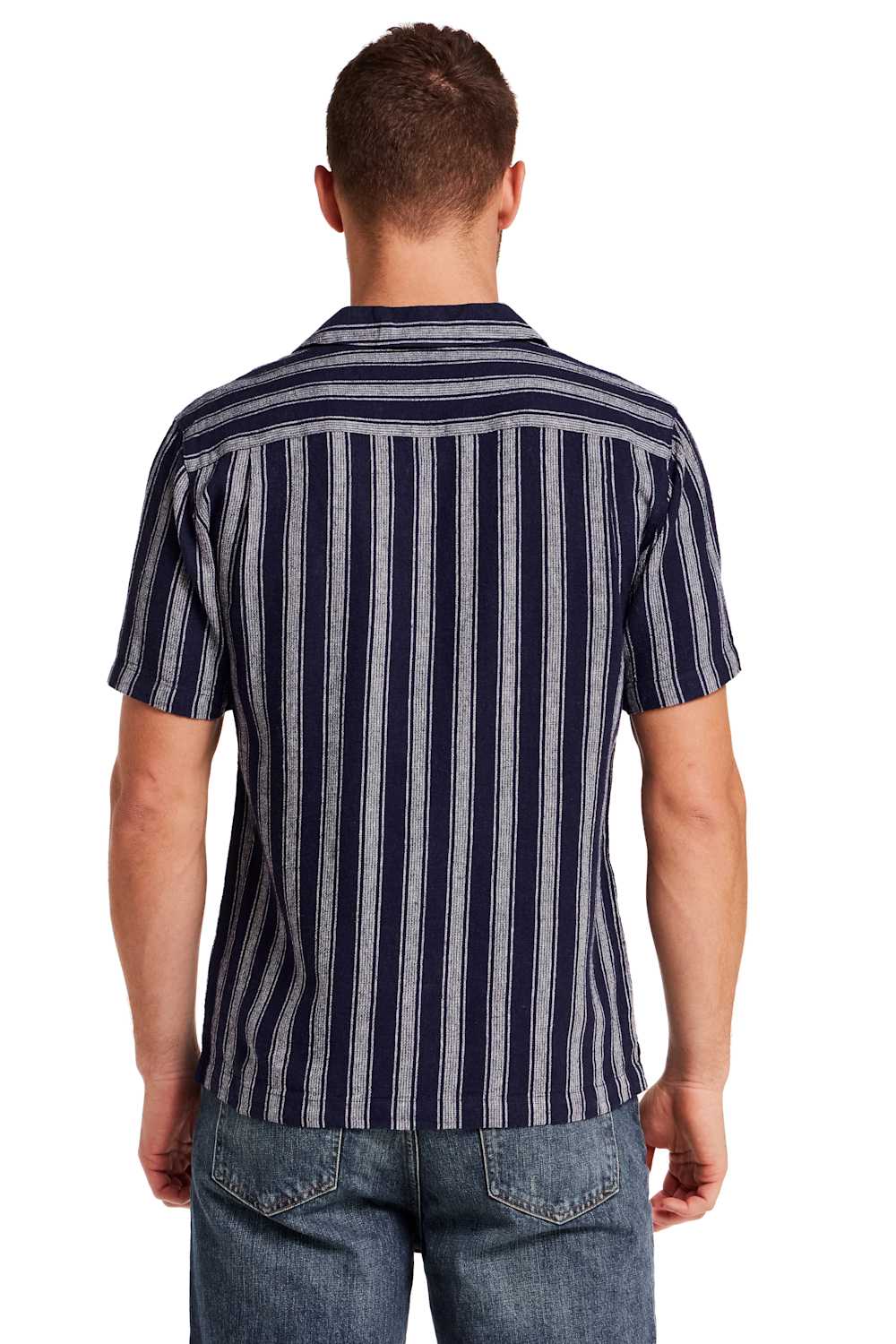 Weatherproof Vintage Linen Camp Shirt for Men in Navy Stripe; Man wearing a striped shirt and jeans on a white background