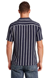 Weatherproof Vintage Linen Camp Shirt for Men in Navy Stripe; Man wearing a striped shirt and jeans on a white background