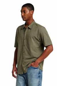 Weatherproof Vintage Neat Coat Knit Button Up Shirt for Men in Grapeleaf; Man wearing a green shirt and blue jeans on a white background