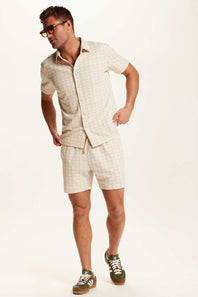 Weatherproof Vintage Knit Jacquard Coatfront Shirt for Men in Cream; Man wearing a beige linen suit with shorts on a white background