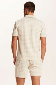 Weatherproof Vintage Knit Jacquard Coatfront Shirt for Men in Cream; Man wearing a beige checkered shirt and shorts set on a white background