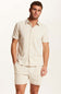 Weatherproof Vintage Knit Jacquard Coatfront Shirt for Men in Cream; Man wearing a matching beige shirt and shorts set on a white background