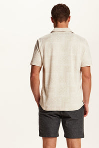 Weatherproof Vintage Bandana Camp Shirt for Men in Tan; Man wearing a beige short-sleeve shirt and gray shorts on a white background