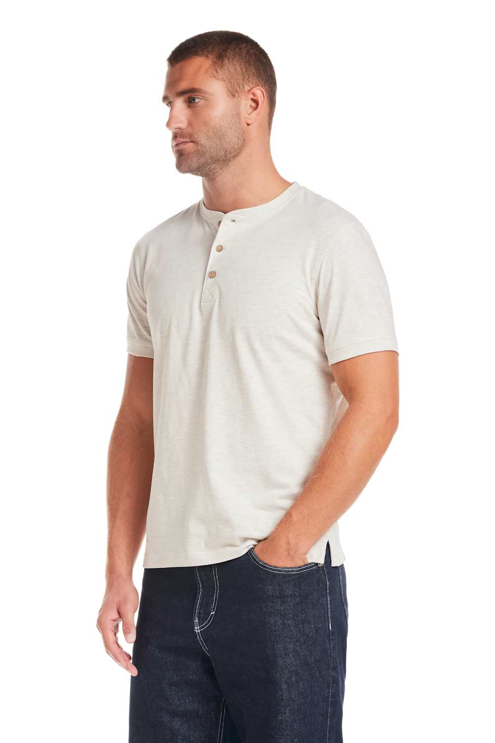 Weatherproof Vintage Jersey Henley Shirt for Men in Oatmeal; Man wearing a beige henley shirt and dark jeans on a white background