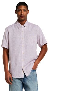 Weatherproof Vintage Cotton Linen Solid Button Down Shirt for Men in Rose; Man wearing a light purple short-sleeve shirt with white buttons on a white background