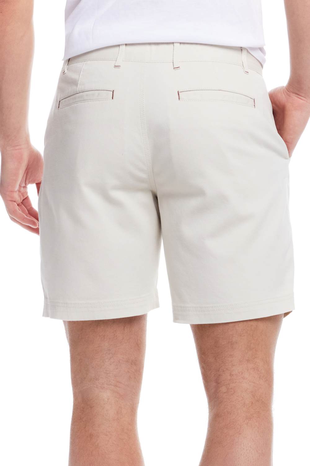 Beige shorts worn by a person on a white background