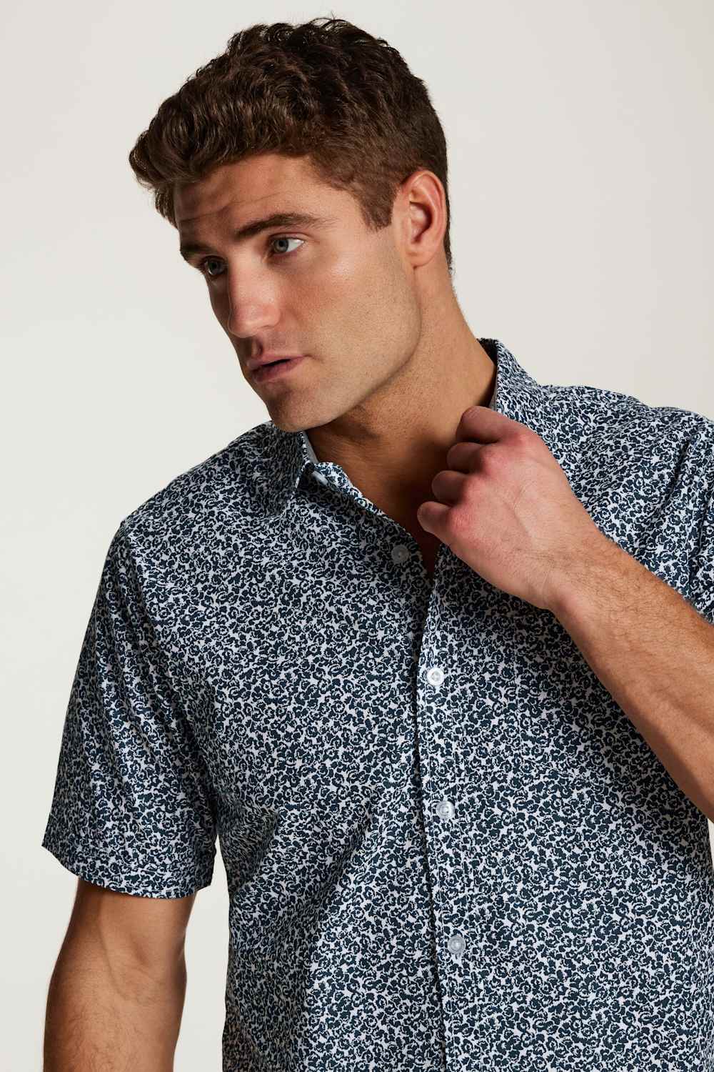 Weatherproof Vintage Poplin Button Up Shirt for Men in Teal; Man wearing a patterned shirt against a plain background
