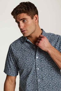 Weatherproof Vintage Poplin Button Up Shirt for Men in Teal; Man wearing a patterned shirt against a plain background