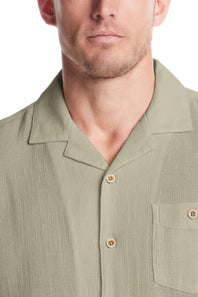 Weatherproof Vintage Cotton Airtex Shirt for Men in Seagrass; Close-up of a man wearing a green button-up shirt with a white background