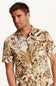 Weatherproof Vintage Camp Collar Printed Shirt for Men in Wheat; Man wearing a patterned shirt with nature design on a plain background