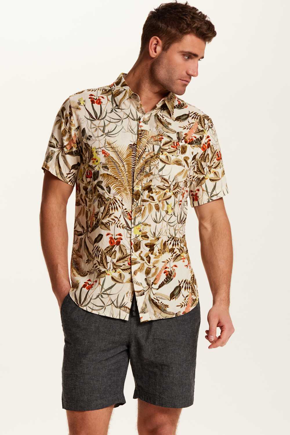 Weatherproof Vintage Camp Collar Printed Shirt for Men in Wheat; Man wearing a patterned shirt and dark shorts on a plain background
