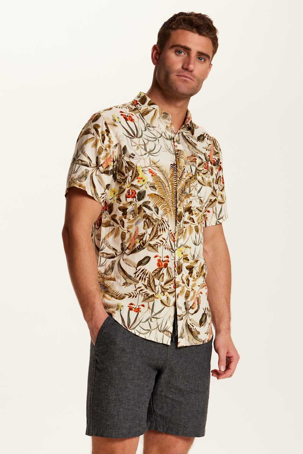 Weatherproof Vintage Camp Collar Printed Shirt for Men in Wheat; Man wearing a patterned shirt and shorts on a plain background