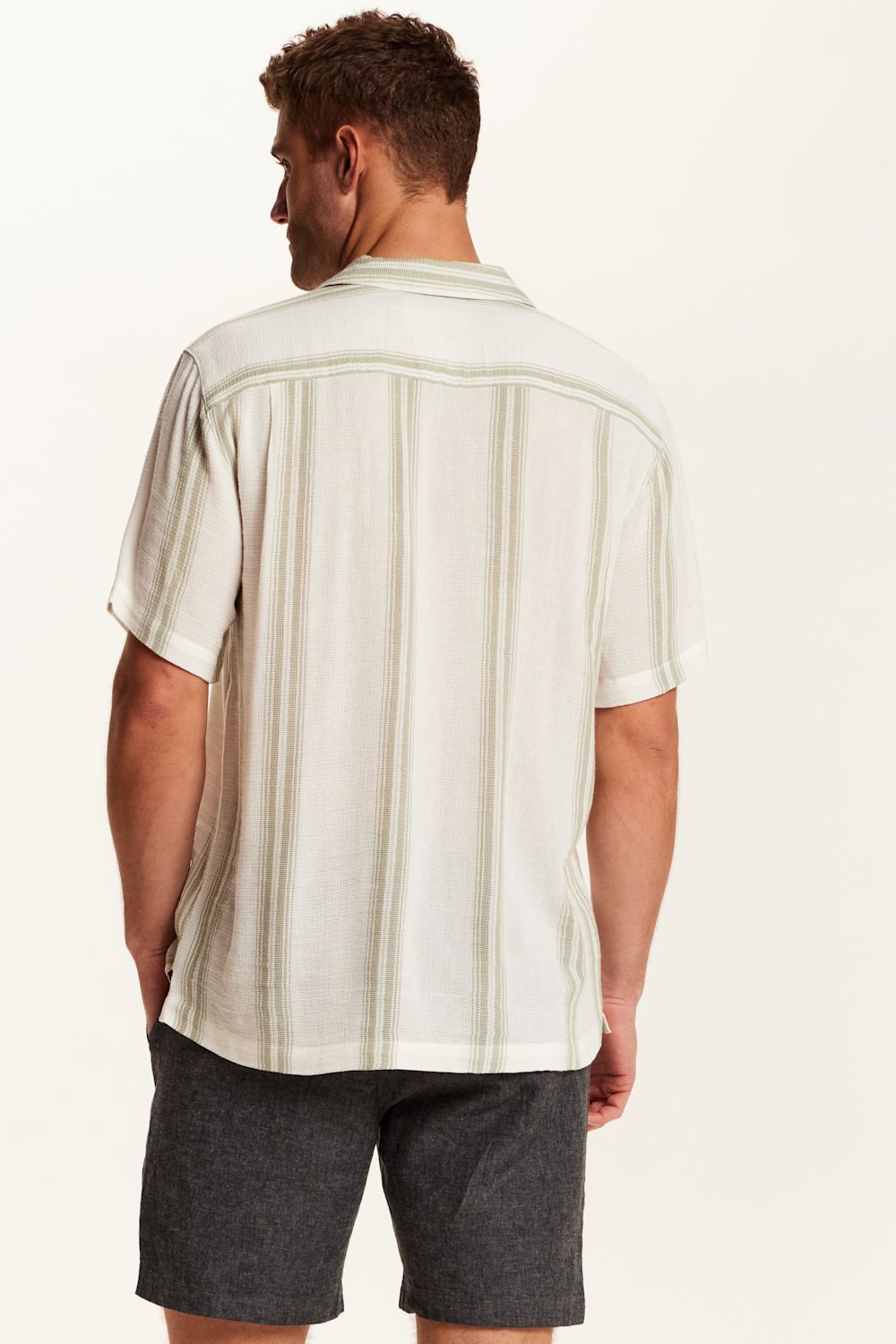 Weatherproof Vintage Striped Cotton Airtex Shirt for Men in Seagrass; Man wearing a white and beige striped shirt with dark shorts on a white background