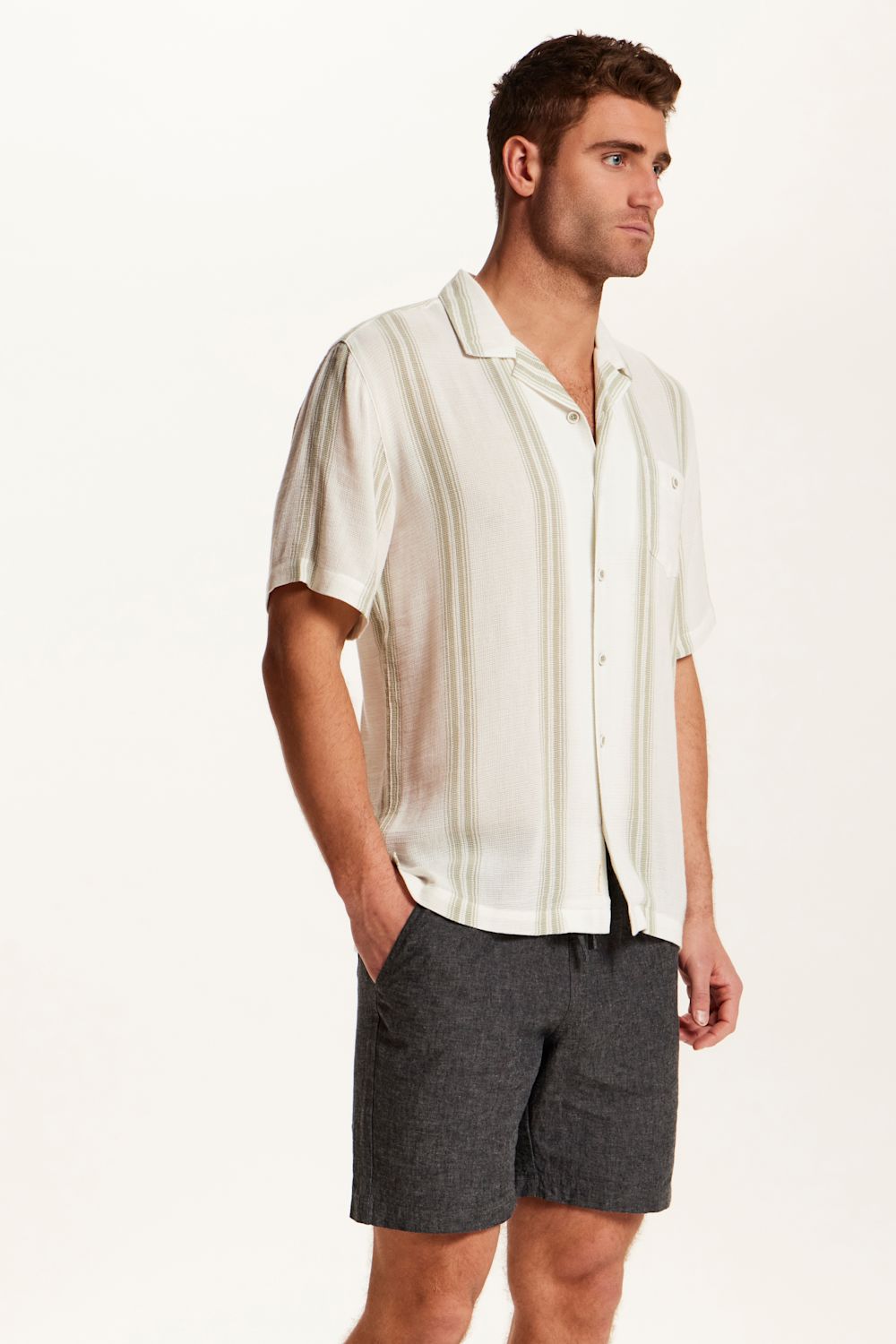 Weatherproof Vintage Striped Cotton Airtex Shirt for Men in Seagrass; Man wearing a white shirt and gray shorts on a plain background