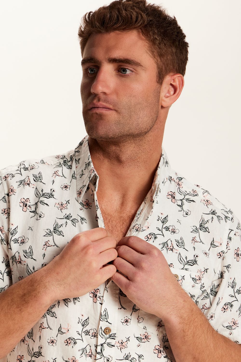 Weatherproof Vintage Linen Rayon Printed Shirt for Men in Cloud Pink; Man wearing a floral shirt against a plain background