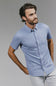 Man wearing a blue patterned shirt against a gray background