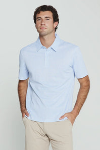 7Diamonds Aires Polo for Men in Light Blue; Man wearing a light blue shirt and beige pants against a plain background