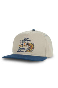 Beige and blue cap, titled the Sendero Provisions Co. Leroy Brown Hat in Khaki/Navy, with fishing-themed design on a white background
