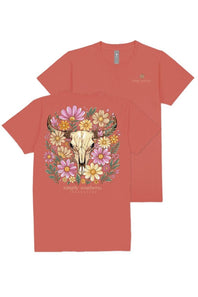 A coral red short-sleeve t-shirt shown from both front and back. The front features a large graphic of a white bull skull surrounded by colorful pink, yellow, and purple wildflowers