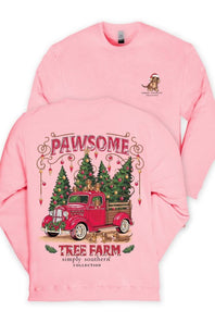 A pink crewneck sweatshirt shown from both front and back. The front features a graphic of a red vintage truck carrying Christmas trees, with the text 'PAWSOME TREE FARM simply southern collection' and a small dog wearing a Santa hat on the left chest.