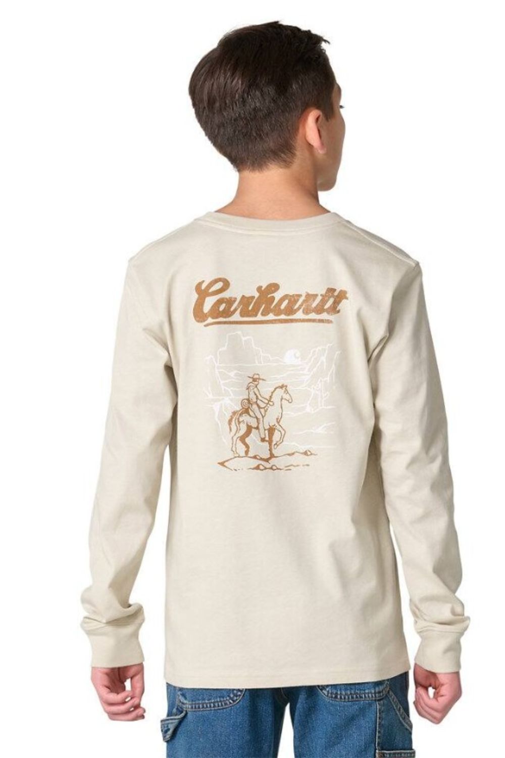 A child shown from the back wearing a light beige long-sleeve t-shirt with a brown Carhartt logo and cowboy graphic on the back, paired with blue jeans against a white background.