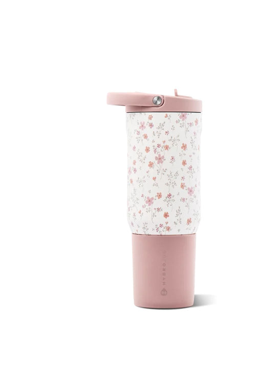A travel tumbler with a dusty pink base and lid, featuring a white body printed with a small pink and orange floral pattern, shown on a white background.