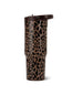 A travel tumbler with a brown and black leopard print pattern and a dark brown lid, shown on a plain white background.